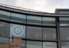 Donor Revolt Erupts — DNC in Survival Curved glass facade of a modern office building