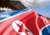 North Korean DNA Powers Iran’s Missiles North Korea flag draped over a mountainous landscape
