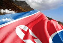 North Korea flag draped over a mountainous landscape