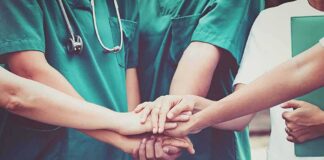 medical team stacking hands in unity