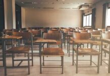 Fake Heritage Scandal – Philly Classroom Deceived Empty classroom with rows of wooden desks and chairs