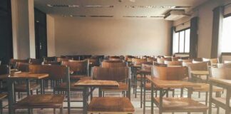 Empty classroom with rows of wooden desks and chairs