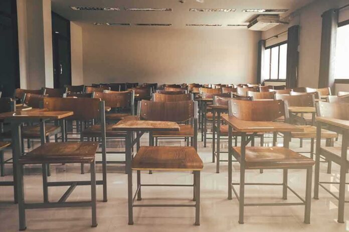 Empty classroom with rows of wooden desks and chairs