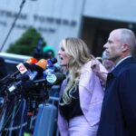 Press Conference Meltdown Raises Eyebrows Woman addressing a press conference with multiple microphones