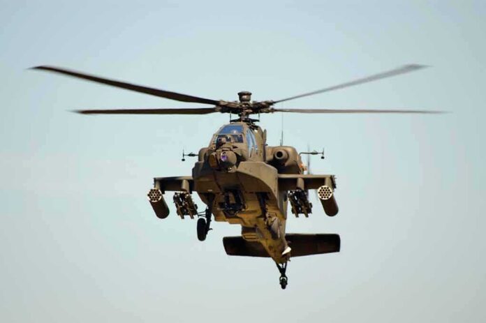 Military Apache helicopter flying in the sky