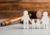 Paper cutout family with gavel in background