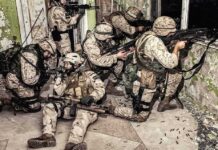 Late-Night Tip Triggers Major Lockdown soldiers in camouflage gear take positions inside a damaged building