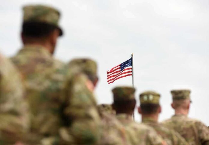 U.S. flag flying above a formation of soldiers in uniform