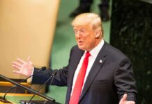 Ballroom Walkthrough JOLTS State Dinner Donald Trump speaking at a podium with arms outstretched