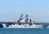 Ballistic Salvo Fizzles—Payback Hits Hard Aircraft carrier sailing on calm blue water
