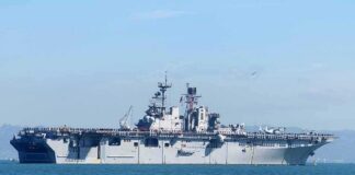 Aircraft carrier sailing on calm blue water