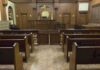 Shock Leniency: Mayor’s Crimes, Slap-On-Wrist Sentence Interior view of an empty courtroom with wooden benches and a judges bench
