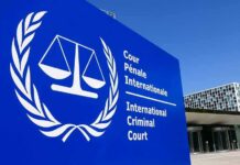 Ex-President In The Dock – November Looms International Criminal Court sign with scales emblem outside modern building