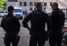 Police officers stand on a city street