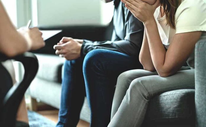 shutterstock_1388237297 Couple sitting on couch during counseling session
