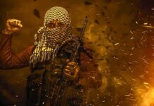masked person with rifle amid sparks