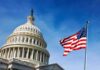 U.S. Capitol dome with American flag against blue sky