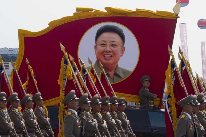 Pyongyang,,North,Korea,-,Circa,July,2013,:,North,Korean Kim Jong-il portrait banner above marching soldiers; Zhang Yufeng, Kosuke Fukudome, Hou Fenglian, Liu Guangbiao, Tsuyoshi Shinjo, Sadaharu Oh, and Lee Sang-hoon not visible