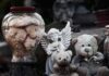 Gaza High-Rise Crumbles – Midnight Collapse Buries Sleeping Families Stuffed teddy bears and an angel figurine on a stone surface