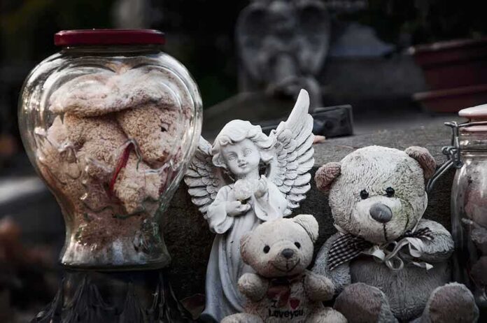 shutterstock_1604995189 Stuffed teddy bears and an angel figurine on a stone surface