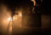Micro-Dramas Explode – Beijing Greenlights All-AI Film Pipeline Film camera and clapperboard in smoky dramatic lighting
