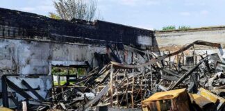Burned building interior with collapsed charred debris