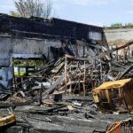 Retail Giant Scorched — Who’s Really Targeted? Burned building interior with collapsed charred debris