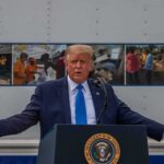 Addiction Hail Mary— TRUMP Greenlights Psychedelic Lifeline Donald Trump speaks at a podium with arms outstretched