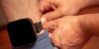 Person fastening an ankle monitor on a leg