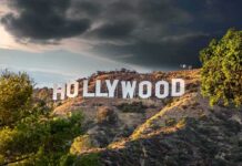 Jewish A-Listers Defy Antisemitism Smear Hollywood sign on hillside under dramatic clouds