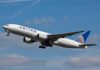 Passenger jet taking off against a blue sky