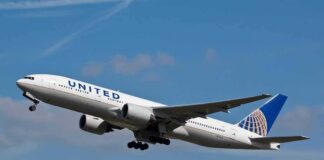 Passenger jet taking off against a blue sky