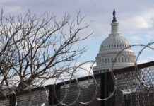U.S. Capitol dome behind barbed security fence