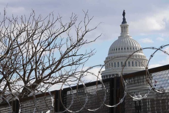 shutterstock_1900672174 U.S. Capitol dome behind barbed security fence