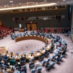 Zuckerberg Drops In, Hands-Off AI Push Stuns Regulators Delegates seated around a circular conference table in a large chamber