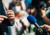 White House Blacklist – Media Offenders List Triggers Purge Microphones held toward a speaker at an outdoor press event