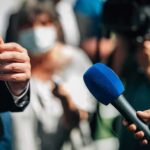White House Blacklist – Media Offenders List Triggers Purge Microphones held toward a speaker at an outdoor press event