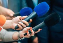 NYC Slams Brakes On Robot Tutors — 600,000 Affected Reporters holding colorful microphones