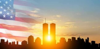 New York City skyline with twin towers at sunrise and American flag overlay