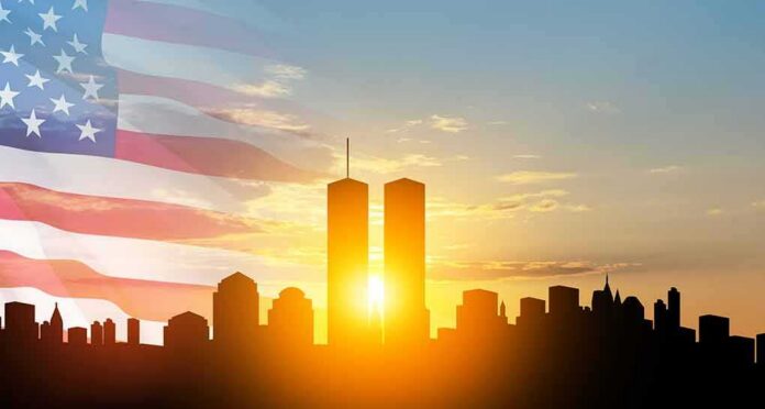 shutterstock_2194199957 New York City skyline with twin towers at sunrise and American flag overlay