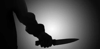 Silhouette of a person holding a knife