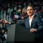 Josh Shapiro speaking at a podium before an audience