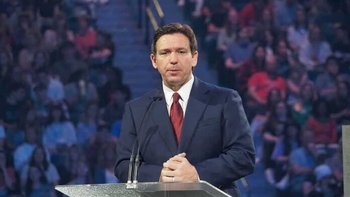 man in suit speaking at a podium
