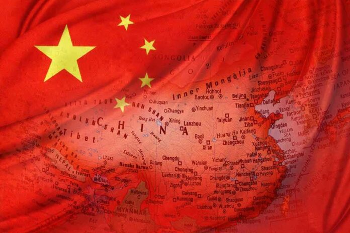 shutterstock_249619855 Chinese flag overlaid on a map of China