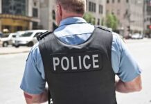 Imposter Lights, Real Felonies – Fake Cop Calls 911 Police officer in uniform from behind on a city street