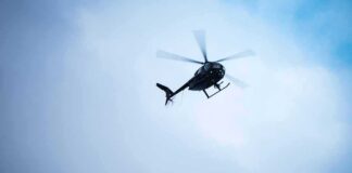 helicopter flying through cloudy sky