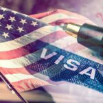 American flag overlaid on a U.S. visa and a pen