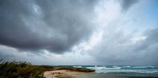 Storm clouds over a rocky beach shoreline