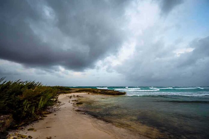 shutterstock_732613378 Storm clouds over a rocky beach shoreline