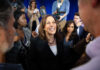 Kamala Harris smiling among supporters with Maya Harris nearby
